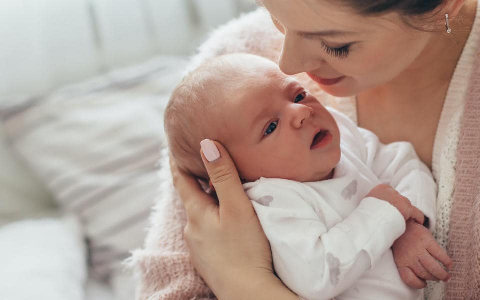 Mother holds toddler